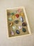 Tumbled gemstones in a wooden box