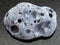 tumbled gray pumice stone on dark background