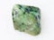 tumbled green Grossular garnet gemstone on white