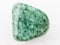 tumbled green Jadeite gemstone on white marble