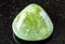 tumbled Grossular (green garnet) rock on black