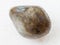tumbled labradorite gem stone on white marble