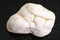 tumbled magnesite stone on dark background