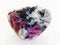 tumbled pink Corundum crystals in rock on white