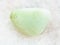 tumbled Prasiolite gemstone on white marble