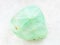 tumbled Prehnite gemstone on white marble