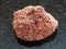 tumbled red pumice stone on dark background