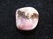 tumbled Rhodochrosite gemstone on dark