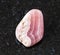 tumbled Rhodochrosite rock on black