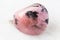 Tumbled Rhodonite rock on white marble