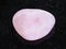 tumbled Rose Quartz gem stone on dark