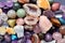 Tumbled and rough gemstones and crystals of various colors. Amethyst, geode amethyst, rose quartz, agate, apatite, aventurine,