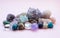 Tumbled and rough gemstones and crystals of various colors. Amethyst, rose quartz, agate, apatite, aventurine, olivine, turquoise