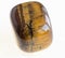 tumbled tiger\'s eye (tiger-eye) gem on white