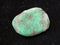 tumbled Variscite gemstone on dark background