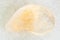 tumbled yellow Citrine gemstone on white marble