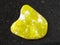 tumbled yellow Lizardite gemstone on dark