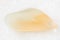 tumbled yellow moonstone (adularia) gem on white