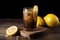 tumbler with iced coffee and slice of lemon on wooden background