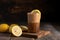 tumbler with iced coffee and slice of lemon on wooden background