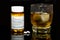 Tumbler of liquor and hydrocodone/APAP prescription.  Mixing Drugs and alcohol concept photo