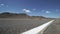 Tumbleweed Blows Across A Road in the Desert 2 of 2