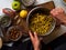 Tumeric bircher meusli being prepared on kitchen table in natural light