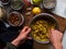 Tumeric bircher meusli being prepared on kitchen table in natural light