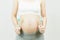 A tummy of a pregnant woman with spoon and fork,Pregnancy health care preparing for baby concept.Motherhood among teenage mother,