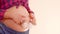 Tummy of a pregnant woman walks with cute little gloves on her big pregnant belly. Expecting mother to play with