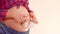 Tummy of a pregnant woman walks with cute little gloves on her big pregnant belly. Expecting mother to play with