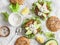 Tuna burger on a light background, top view. Burger with tuna, avocado and mustard sauce,