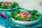 Tuna salad with bell pepper cucumber onion and lettuce on green tablecloth with batik pattern