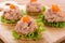 Tuna salad with cracker on wooden background