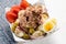 Tuna salad with potatoes and boiled egg called nicoise on white background