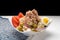 Tuna salad with potatoes and boiled egg called nicoise on white background