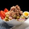 Tuna salad with potatoes and boiled egg called nicoise on white background