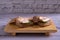 Tuna slices sandwich with bread on a wooden cutting board on wood background closeup