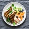 Tuna, spinach, mozzarella hot toast and fresh fruit - delicious healthy breakfast, brunch, snack on a gray background, top view