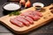 tuna steaks placed on a bamboo board, sprinkled with sesame seeds