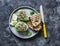 Tuna stuffed avocado - delicious healthy food on a dark background, top view