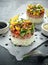 Tuna sushi stacks with mango, cucumber, tomatoes salsa served with balsamic vinegar, nigela ans sesame seeds