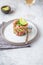 Tuna tartare tartar with avocado and quinoa. gourmet presentation with culinary ring on wite plate