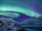 Tungeneset rocks and Aurora Borealis light. Senja islands, Norway. Stars and northern light.