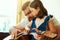 Tuning into a developing talent. an adorable little girl playing the guitar with her father at home.