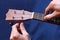 Tuning the first string of ukulele, closeup