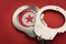 Tunis flag and police handcuffs. The concept of crime and offenses in the country. concept of crime in the state or