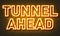 Tunnel ahead neon sign on brick wall background.