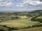 Tunning vibrant landscape image of English countryside on lovely Summer afternoon overlooking rolling hills and country villages