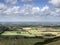 Tunning vibrant landscape image of English countryside on lovely Summer afternoon overlooking rolling hills and country villages